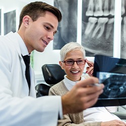 A dentist reviewing an X-ray with a patient