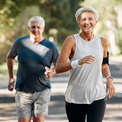 Couple smiling while running outside