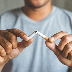 Closeup of patient breaking cigarette