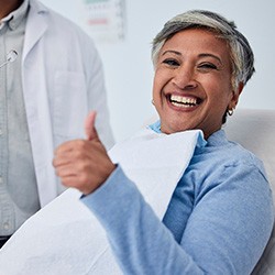 A woman smiling at the dentist