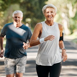 Couple smiling while running outside