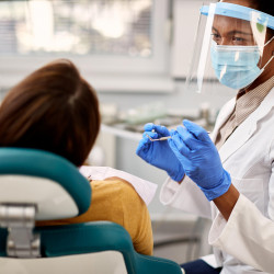 a patient undergoing in-office teeth whitening treatment
