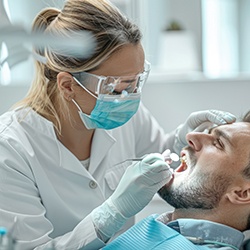 Dentist examining patient's teeth