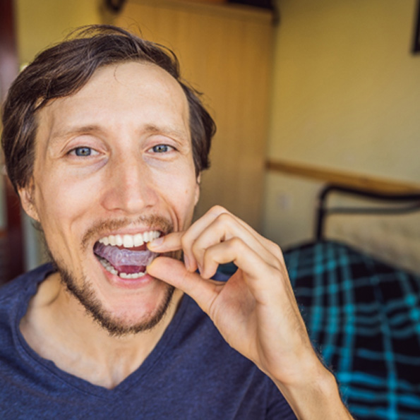 Clear aligner tray held by Warrenton patient 