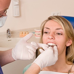 Warrenton patient brushing teeth with aligners removed 