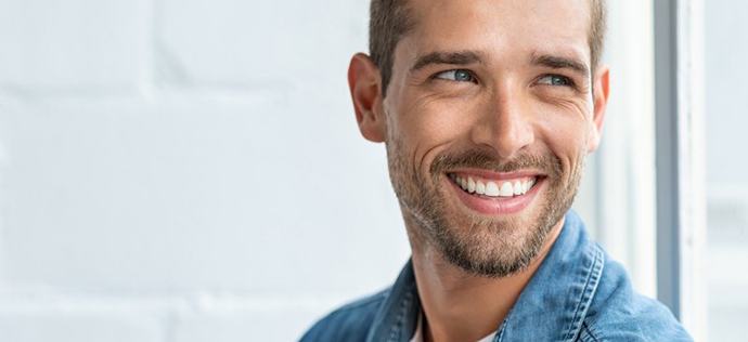 a man smiling with bright teeth