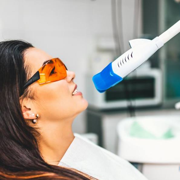 a patient undergoing in-office teeth whitening treatment
